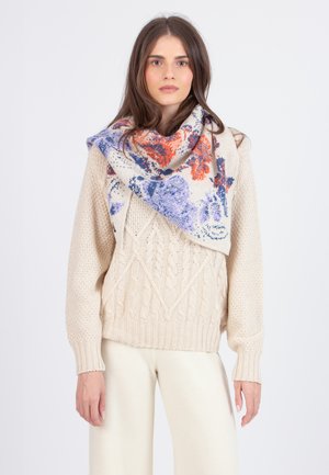 Beige knitted sweater with a textured cable pattern, paired with a triangular scarf featuring floral designs in blue and orange hues.