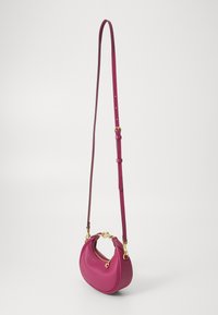 Fuchsia leather crossbody bag with a rounded shape, gold hardware accents, and an adjustable strap. Features a zip closure.