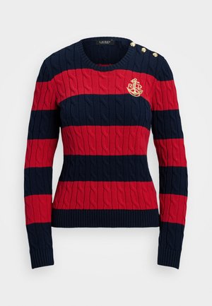 Pītas džemperis ar tumši zilu un sarkanu horizontālu svītru rakstu, ar kabelīšu zīmējumu, ribotu aproču un zelta pogām uz kreisā pleca. Izšūts enkura logo.