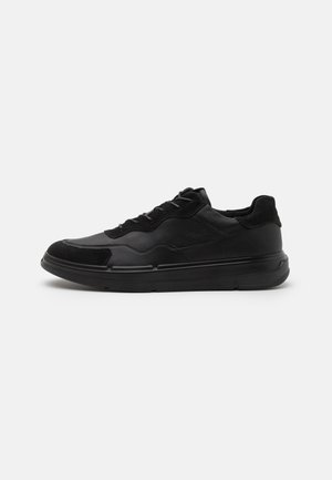Black athletic shoes with a smooth leather and suede texture, featuring a rounded toe, lace-up closure, and a thick black sole.