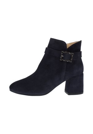 Black suede ankle boot with block heel and decorative textured buckle strap on outer side.