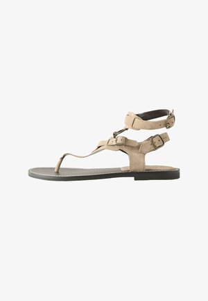 Beežid platvormsandal musta tallaga, millel on kolm reguleeritavat pannalrihma ümber pahkluu ja jala ning varbaring.