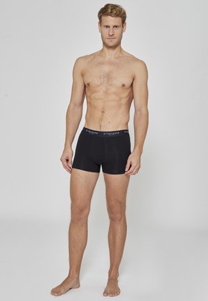 Sorte bokserbriefs for menn med tettsittende design, myk tekstur og elastisk linning med merke. Glatt stoff og lengde til midten av låret.