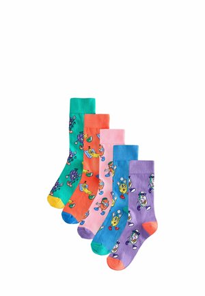 Cinque paia di calzini colorati in cotone con personaggi di frutta dei cartoni animati. I design includono sfumature di verde, arancione, rosa e viola con risvolti a contrasto.