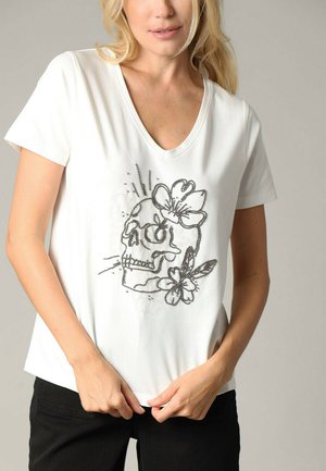 Witte short-sleeve v-hals t-shirt met een zwart schedel- en bloemdesign, versierd met pailletten, gemaakt van een gladde katoenmateriaal.