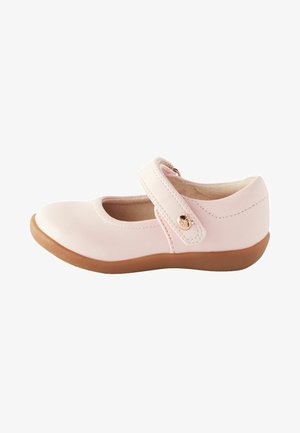 Pink leather Mary Jane shoe with a rounded toe, adjustable strap, and tan rubber sole. Features a small gold accent on the strap.