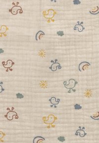 Cotton fabric with a cream background featuring whimsical patterns of colorful birds, sun, rainbows, and clouds in yellow, blue, green, and red.