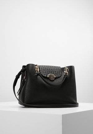 Black textured leather handbag with patterned flap, gold-tone logo clasp, and adjustable shoulder strap, displayed on white surface.