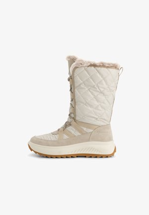 Botte d'hiver beige matelassée avec doublure en fourrure, devant lacé et semelle en caoutchouc épaisse avec des crampons profonds pour une meilleure traction.