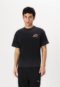Black cotton short-sleeve t-shirt with a round neckline and front logo detailing. Smooth texture, casual fit.