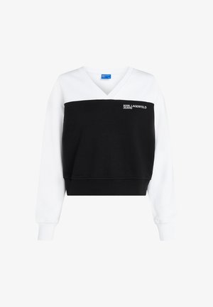 Sudadera recortada en blanco y negro, con escote en V, mangas largas y logo bordado. Fabricada con una suave mezcla de algodón.