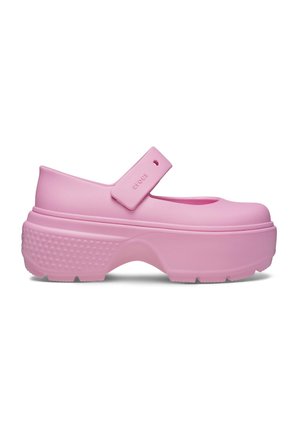 Pink clogs with a rounded toe, strap across the instep, and textured sole. Made of flexible material with a thick, chunky platform.