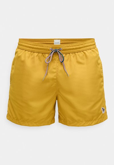 Sárga fürdőnadrág sima, könnyű anyagból. Rugalmas derékrésszel, színes zsinórfűzővel és hímezett logórészlettel.