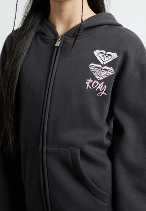 Czarna bluza z kapturem na zamek, wykonana z mieszanki bawełny, z przednią kieszenią i grafiką serca w białym i różowym kolorze. Srebrny akcent na zamku.