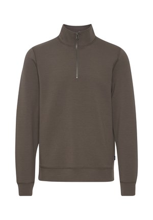 Pull en polaire à col zippé de couleur vert olive foncé, à manches longues, avec une texture lisse et des détails de couture discrets le long des manches et de l'ourlet.