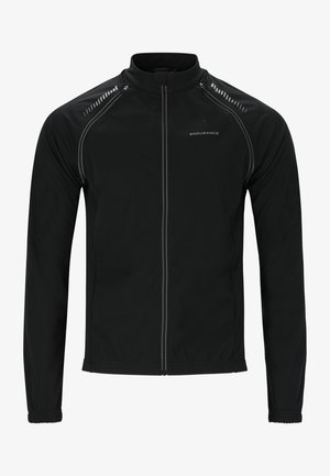 Zwarte sportjack gemaakt van zacht, rekbaar materiaal. Heeft een rits aan de voorkant, een hoge kraag en reflecterende accenten op de schouders en de rits.