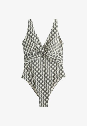 Costume intero con motivo a foglie bianche e nere, dettaglio con nodo attorcigliato sul seno e scollatura profonda a V.