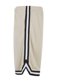 Beige mesh shorts med sort og hvid sidelister, der har en behagelig elastisk talje og en løs pasform.
