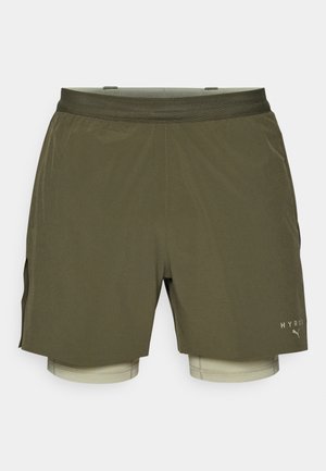 Shorts de sport vert olive avec une couche intérieure beige, dotés d'une ceinture en maille respirante et de fentes latérales pour faciliter les mouvements.