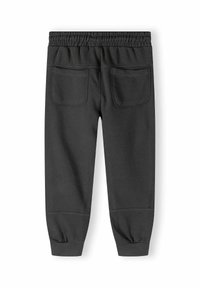 Grijze sweats met een elastische tailleband, twee achterzakken en taps toelopende boorden bij de enkels. Gemaakt van zacht, rekbaar materiaal.