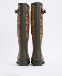 Tall rubber boots with a dark green base and embossed floral pattern in copper tones. Features a buckle accent and textured upper.