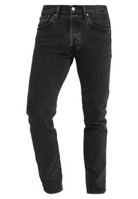 Svarta jeansbyxor med slim fit-design, central knapp och dragkedja, fram- och bakfickor samt synlig strukturerad tygkorn.