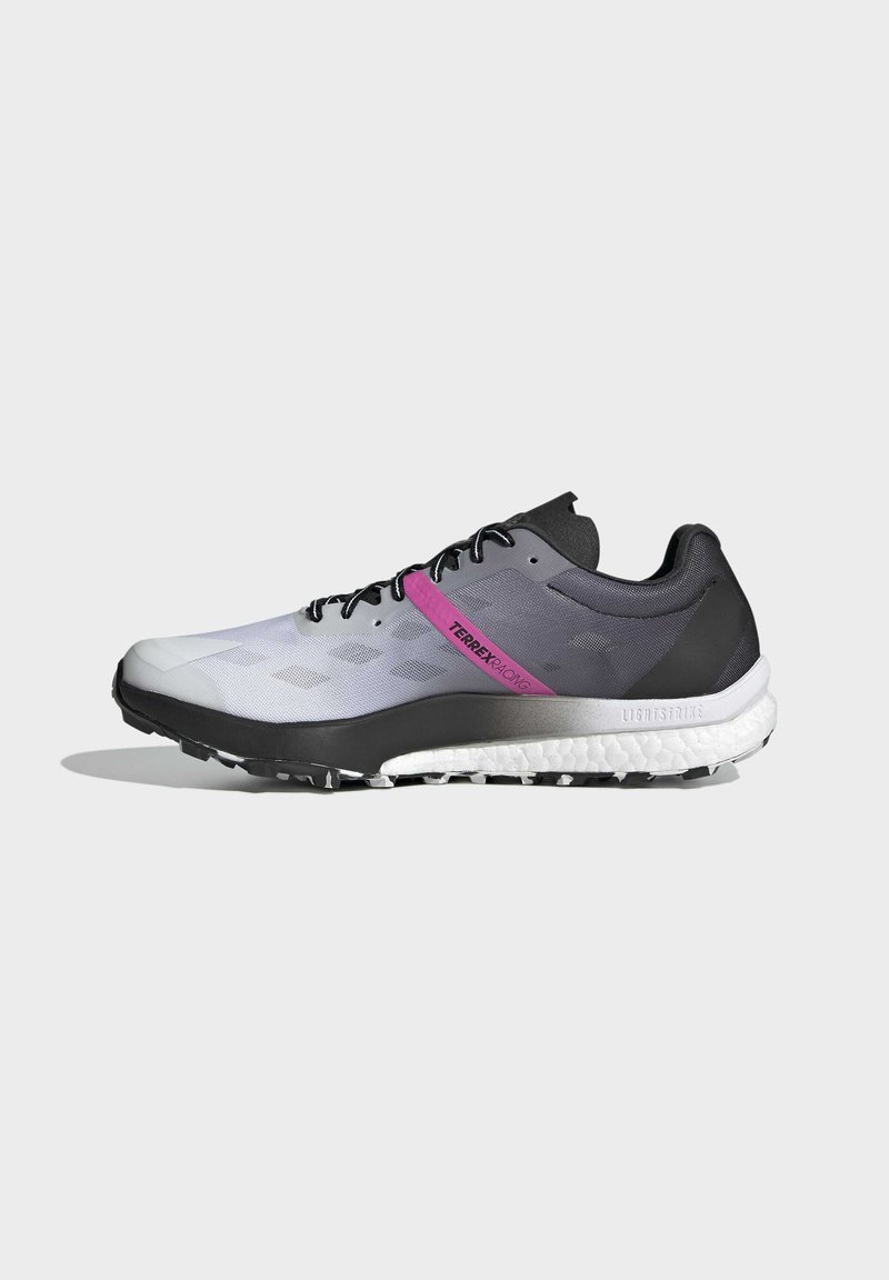 Zapatilla de running ligera con un degradado de gris claro a negro, banda de acento rosa, parte superior texturizada y una suela resistente y acolchada.