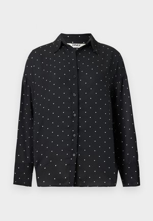 Čierna košeľa s dlhým rukávom na gombíky, s bielymi bodkami a golierom, zobrazená na jednoduchom svetlom pozadí.