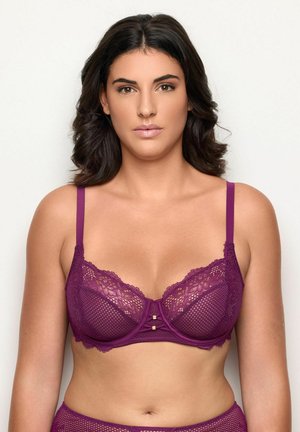 Lilla blonde- og netbh med underwire, justerbare stropper og to guldaccentuer i midten. Har bølgede kanter og teksturerede mønstre.