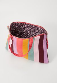 Striped fabric bag with red, pink, green, and yellow vertical stripes; interior features a floral pattern; zip closure and fabric handles.