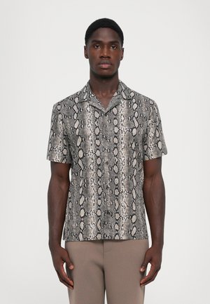 Short-sleeve shirt featuring a black and beige snake print design, made from a smooth material. Classic collar and a relaxed fit.