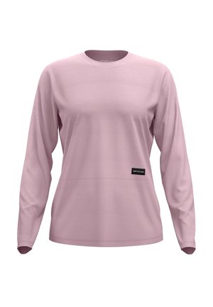 Long-sleeve shirt in soft pink fabric with a round neckline, featuring a horizontal seam detail and a black logo patch on the front.