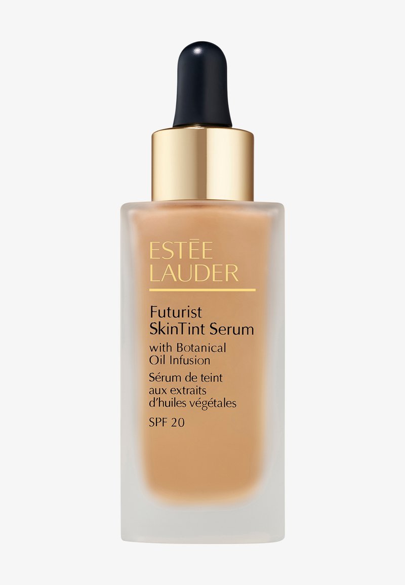Estée Lauder Futurist SkinTint Serum bottle with dropper, SPF 20, containing botanical oil infusion, beige liquid inside frosted glass container.