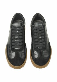 Black sneakers with a mix of glossy leather and suede, featuring textured paneling, flat laces, and a gum rubber sole.