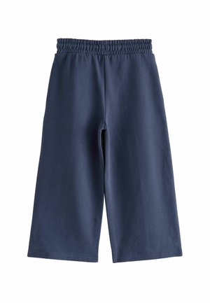 Culottes bleu marine avec une ceinture élastique, fabriquées à partir de coton doux, présentant un design simple et une texture lisse sans motifs.