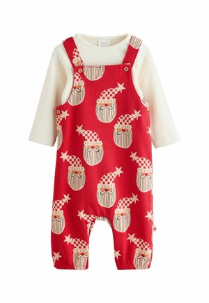 Rote Baumwoll-Latzhose mit weißem Langarmoberteil. Mit einem sich wiederholenden Muster von bärtigen Figuren in festlichen Hüten und Sternen. Knopf-Akzente vorhanden.