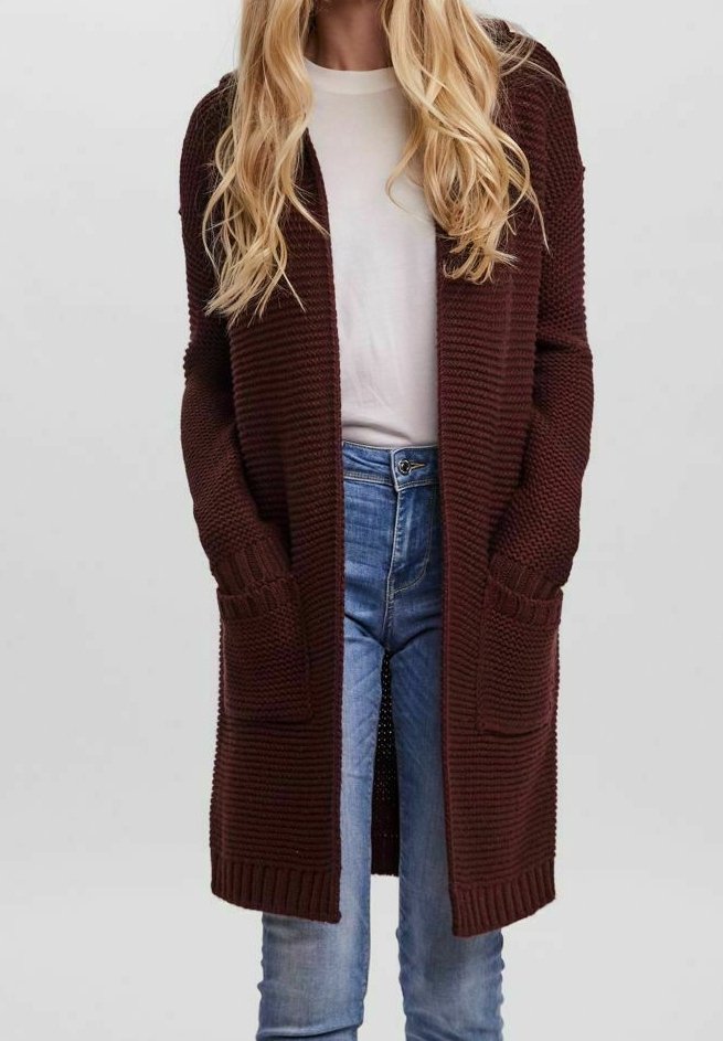 Dark brown knit cardigan with a textured pattern, long sleeves, and side pockets, worn over a white shirt and blue jeans.