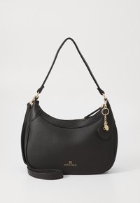 Black leather shoulder bag with pebbled texture, curved design, gold hardware, and heart-shaped charm. Adjustable strap included.