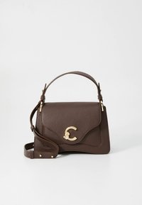 Brown leather handbag with a structured shape, featuring a gold-tone logo accent, a top handle, and an adjustable shoulder strap.