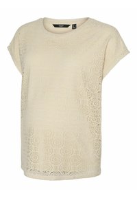 Camiseta de encaje beige con escote redondo y mangas cortas, con intrincados patrones circulares y un ajuste ligeramente holgado.