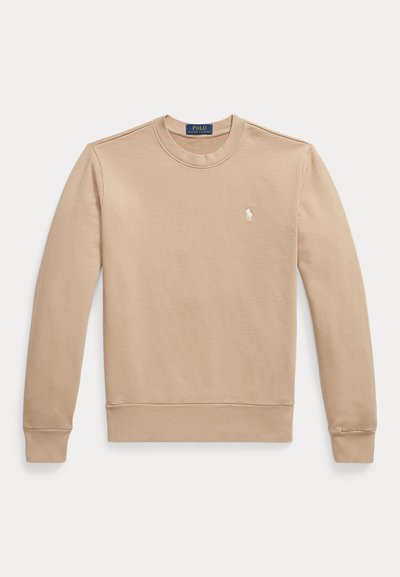 Beige sweatshirt with a crew neck, long sleeves, and ribbed cuffs. Features a small white logo on the left chest. Smooth cotton material.