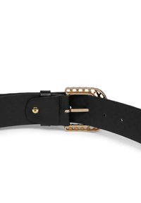 Zwarte leren riem met een gestructureerde afwerking en een metalen gesp in goudkleur met een verfijnd uitsnijd ontwerp. Voorzien van meerdere verstelgaatjes.