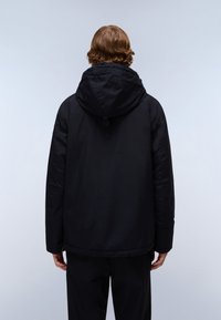 Black hooded jacket with a textured finish, featuring a cinched hem and a vertical pocket detail on the back. Simple, functional design.