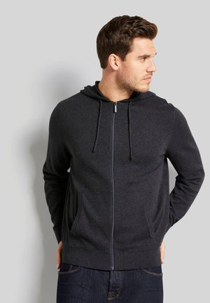 Dark gray zip-up hoodie with a drawstring hood, front pockets, and ribbed cuffs, made from a soft, textured material.