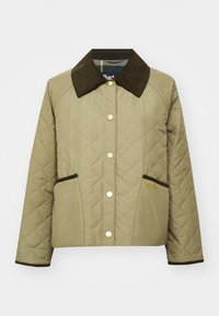 Khaki quilted jacket with dark green corduroy collar, snap buttons, and two side pockets with brown trim. Brand name displayed in gold.