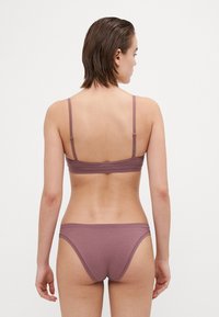 Mulberry-colored wireless bralette and bikini set. Soft, stretchy fabric with thin straps and minimal seams for comfort.