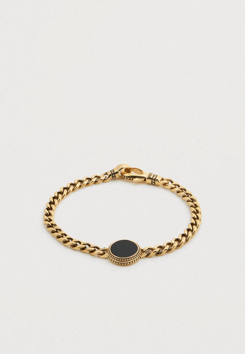 Βραχιόλι αλυσίδας σε χρυσό τόνο με ένα κεντρικό μαύρο κυκλικό πέτρωμα, με κούμπωμα τύπου καβουράκι και υφή γύρω από την πέτρα.