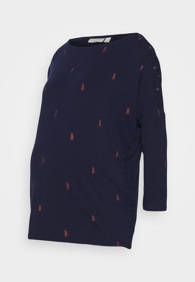 Těhotenský top v námořnické modré barvě s tříčtvrtečními rukávy a kulatým výstřihem, zdobený rozptýlenými červenými peřím a knoflíkovými detaily na rameni.