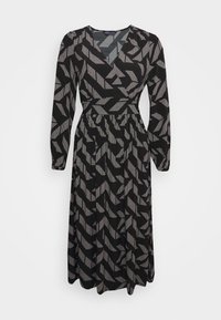 Vestido negro con mangas largas y escote en V. La tela tiene un patrón blanco geométrico. Cintura elástica con falda fluida.