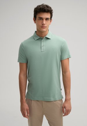Mintgroene polo shirt gemaakt van zachte stof, met een kraag, drie knopen, korte mouwen en een klein logo op de borst.